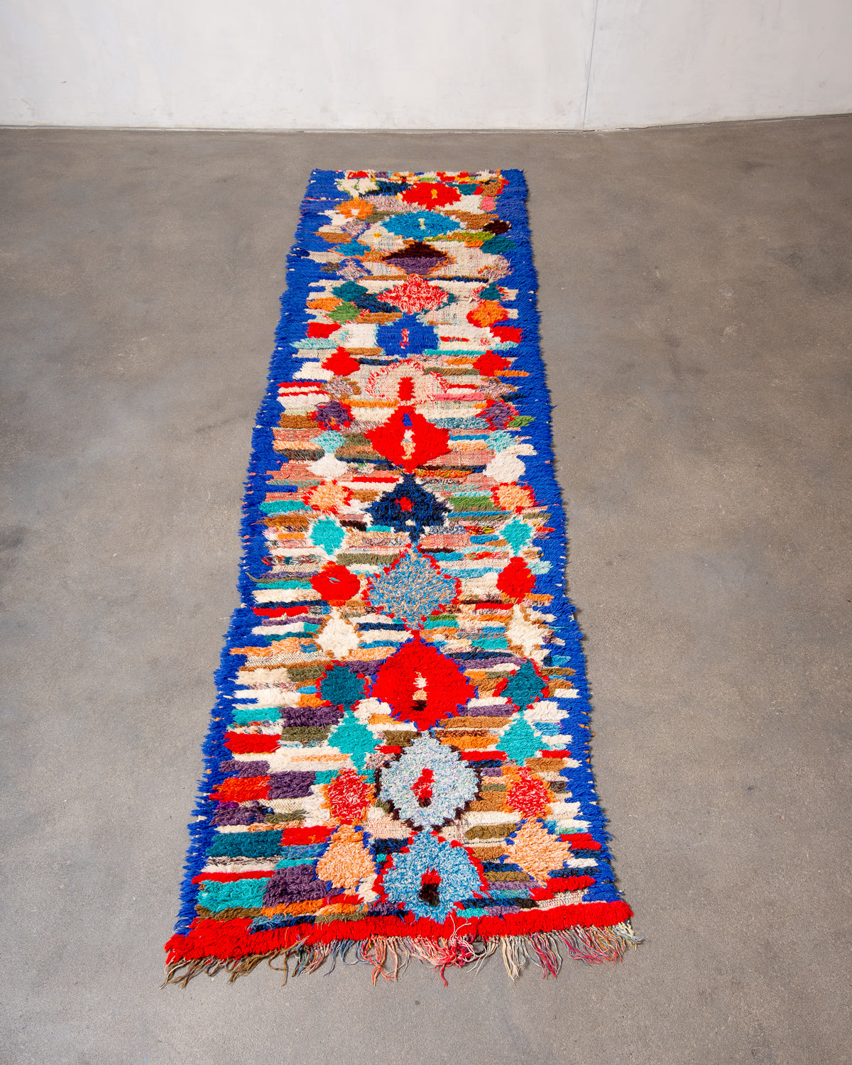 Modern designer vintage handcrafted Berber rug from Morocco. Boucherouite runner rug with beautiful colors and patterns.